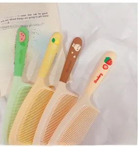 Detail of four colorful cartoon hairbrushes with 3D fruit and bear resin decorations