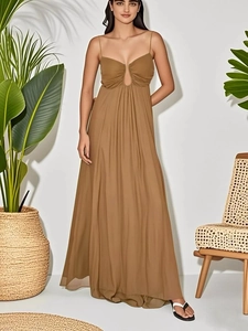 Detail of tan maxi dress featuring U-shape cutout chest and flowy chiffon fabric