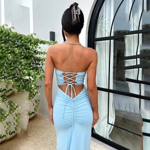 Close-up of a light blue backless maxi dress with stylish tie-back ribbon detail