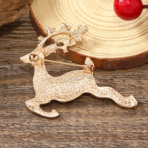 Detailed back view of a golden deer brooch featuring secure pin buckle and textured metal