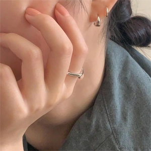 Close-up of S925 sterling silver smile ring and matching earrings worn by a woman