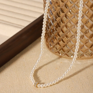 French style pearl necklace with gold diamond-encrusted ring pendant and luxury finish