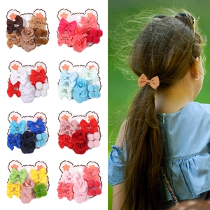 Cute kids hair accessories set featuring bows and floral clips on display cards