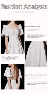 Detail of white bridal dress showing heart-shaped neckline, puff sleeves and pearl accents