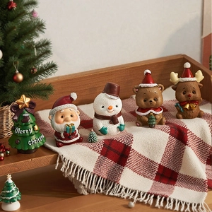 Detailed macro view of festive resin mini Santa, snowman, and reindeer Christmas figurines