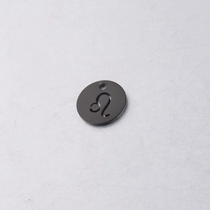 Detailed close-up of a black titanium Leo zodiac charm with cutout symbol for jewelry DIY