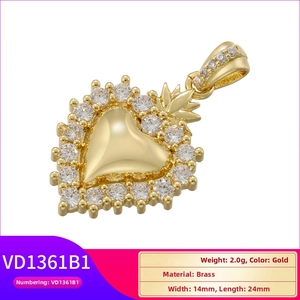 Macro detail of 18K gold plated heart pendant with pavé crystal border and polished brass