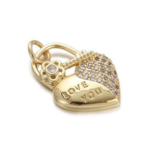 Detailed close-up of a gold heart pendant with Love You engraving and crystal accents
