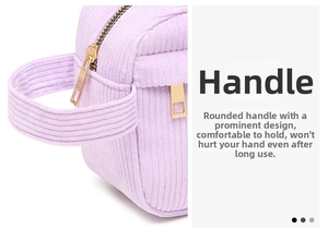 Detail of lavender corduroy makeup bag featuring sturdy handles and gold double zippers