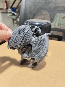 Detailed back view of a grey resin gargoyle figurine showing wing textures and details