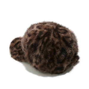 Macro view of leopard print faux fur texture and thick fluffy material on the baseball cap