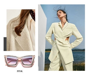 Pink cat-eye sunglasses with pearl and rhinestone details paired with yellow suit fabric