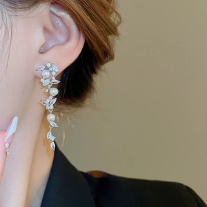 Detailed side view of silver tassel earrings with white pearls and marquise cut zircon stones