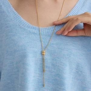 18K gold plated stainless steel Y-necklace with crystal ring pendant on a blue sweater