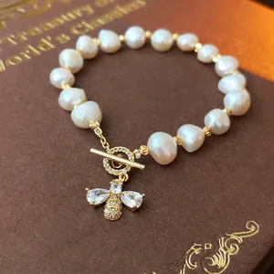 Elegant freshwater pearl bracelet with zircon bee charm and gold toggle clasp