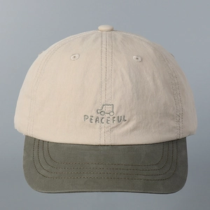 Close-up of car embroidery and Peaceful lettering on two-tone nylon baseball cap