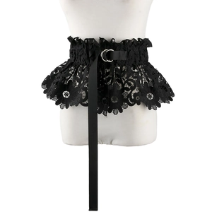 Detail of black lace corset belt with floral cutouts and D-ring buckle on white mannequin