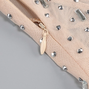 Detailed view of pink mesh fabric with embedded rhinestones and an invisible zipper closure