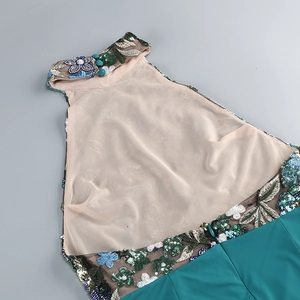 Detail of sequin floral embroidery and halter neckline on a blue formal dress
