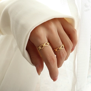 Minimalist gold plated chain link rings with polished finish worn on fingers