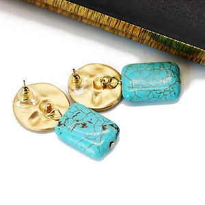 Detail view showing vintage gold textured metal and teal turquoise drop earrings