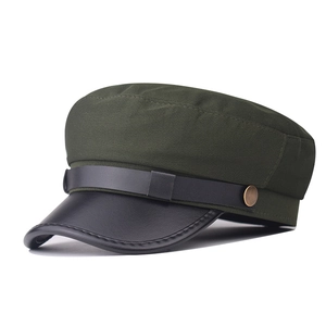 Detail of army green fabric military hat with black leather brim and vintage metal buckle
