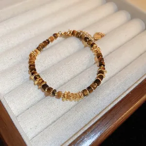 Geometric tiger eye bead bracelet with gold metal accents in a jewelry display box