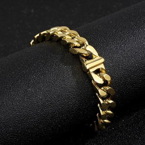Detail of 12mm 18K gold Cuban link chain necklace with secure folding clasp closure