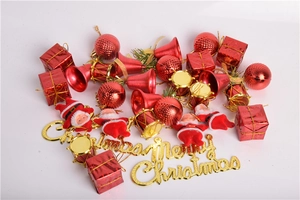 Detail showing red ornaments, golden bells, and Merry Christmas sign on white background