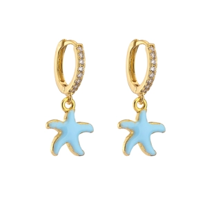 Detailed close-up of golden starfish earrings with blue enamel and micro-pave zircons