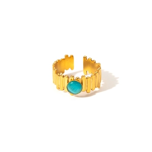 Detail of vintage 18K gold plated ring with turquoise stone and ribbed texture surface