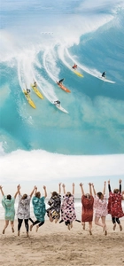 Action shots of quick-dry hooded beach ponchos in various tropical prints and vibrant patterns