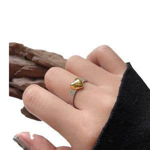 Minimalist S925 sterling silver twisted ring with a polished gold heart on finger