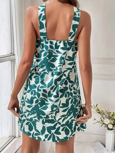 Detail view of backless floral print dress with leaf pattern and halter straps