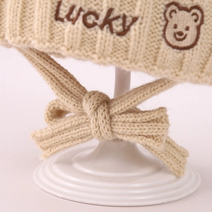 Winter beige knit baby hat with Lucky bear embroidery and warm protective ear flaps