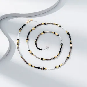 Detail of colorful faceted crystal bead eyewear chain with gold heart charms and lobster clasps