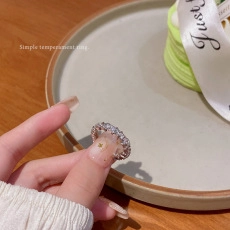 Detailed close-up of a silver thin ring band pavé-set with sparkling round zircons