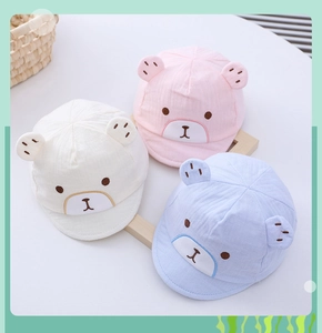 Detailed close-up of newborn cotton baby cap featuring cute bear ears and embroidery