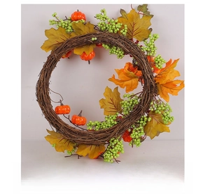 Rear view of autumn wreath with maple leaves and pumpkins on woven vine base