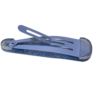 Close-up of a blue glitter snap hair clip with a smooth metallic clasp on white background