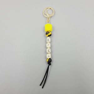 Detail of MAMA letter silicone beads with sunflower pattern and black suede tassel keychain