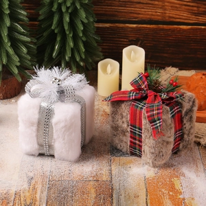 Plush Christmas gift box ornaments with faux fur and pinecones on a cozy wooden surface