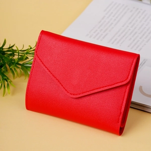 Close-up of red envelope style wallet with lychee pattern texture and fine stitching