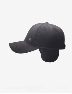 Detail of winter baseball cap showing thick twill fabric and side logo with ear flaps