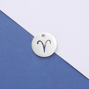 Detailed macro view of silver stainless steel circular Aries zodiac hollow pendant