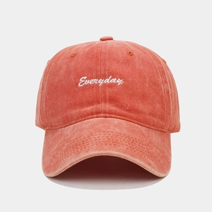 Close-up of the vintage washed brick red baseball cap with white Everyday embroidery