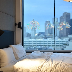 Rainbow prism window stickers in rainbow shape creating colorful effects on bedroom window