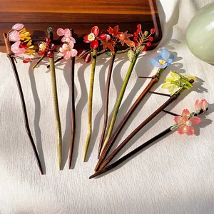Elegant Chinese style pearl flower tassel hair sticks with various floral designs on wood