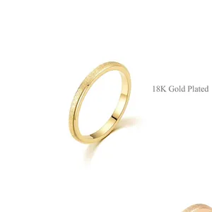 Detailed view of women's 18K gold plated ring with frosted matte surface texture