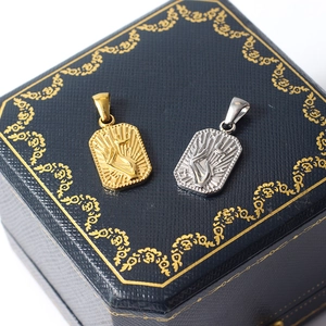 Retro stainless steel sun flower pendant in gold and silver finish on a blue box